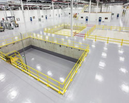 Interior of SAFRAN Aerospace Composite Facility. Large open white room with bright lights.